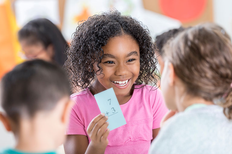 Girl showing math flashcard