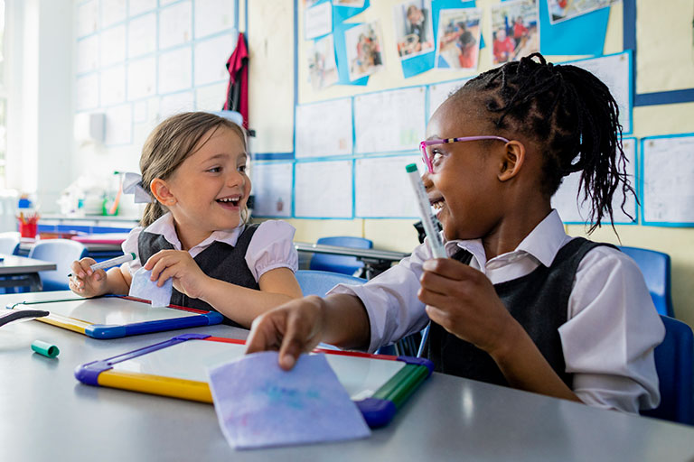 Two young students working together on math