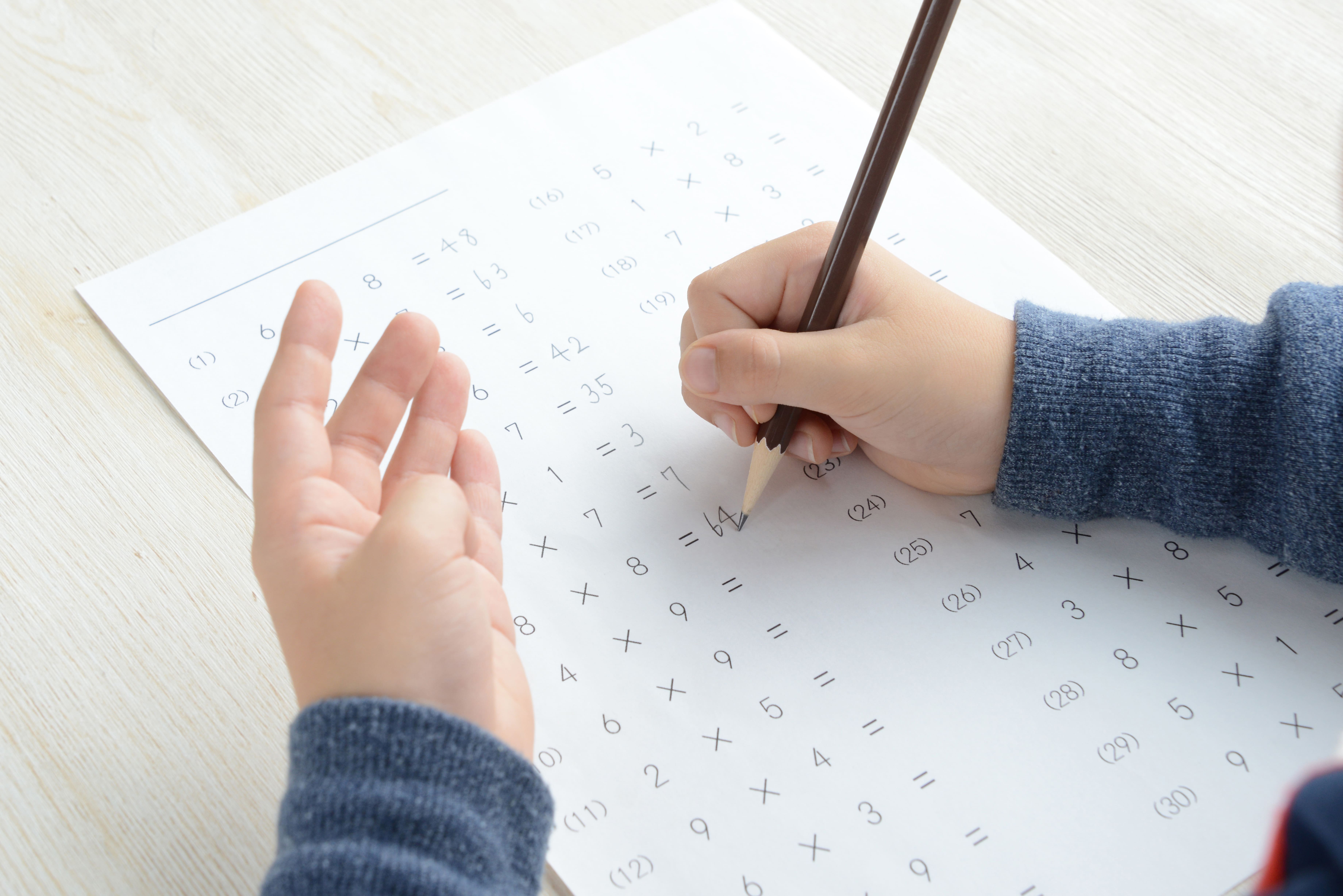 child working on math worksheet